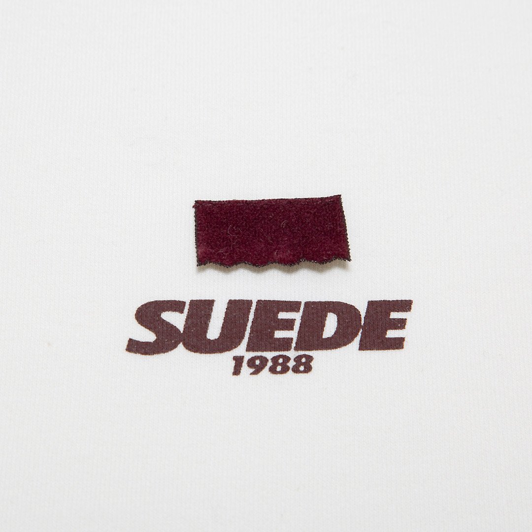 SUEDE1988 burgundy suede flap and printed wordmark, close up