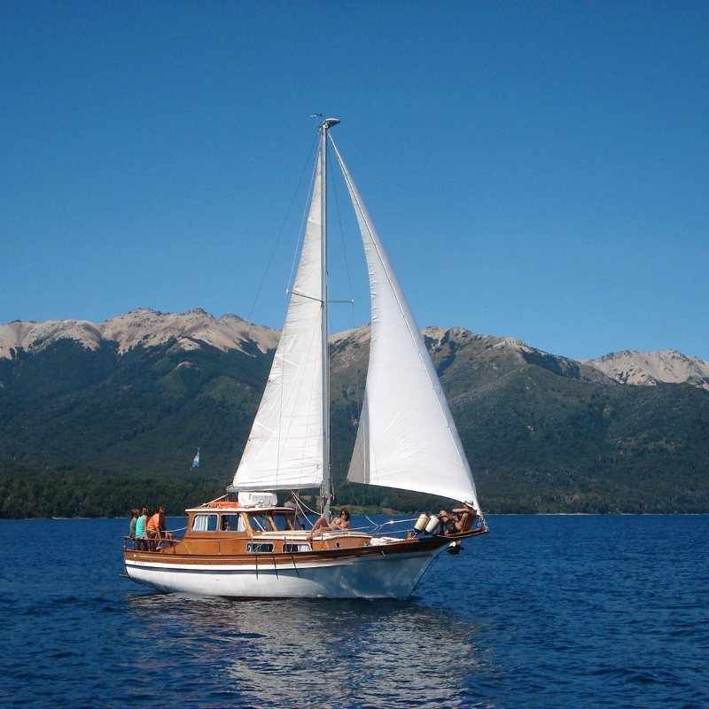 Wooden sailboat on a mountain lake