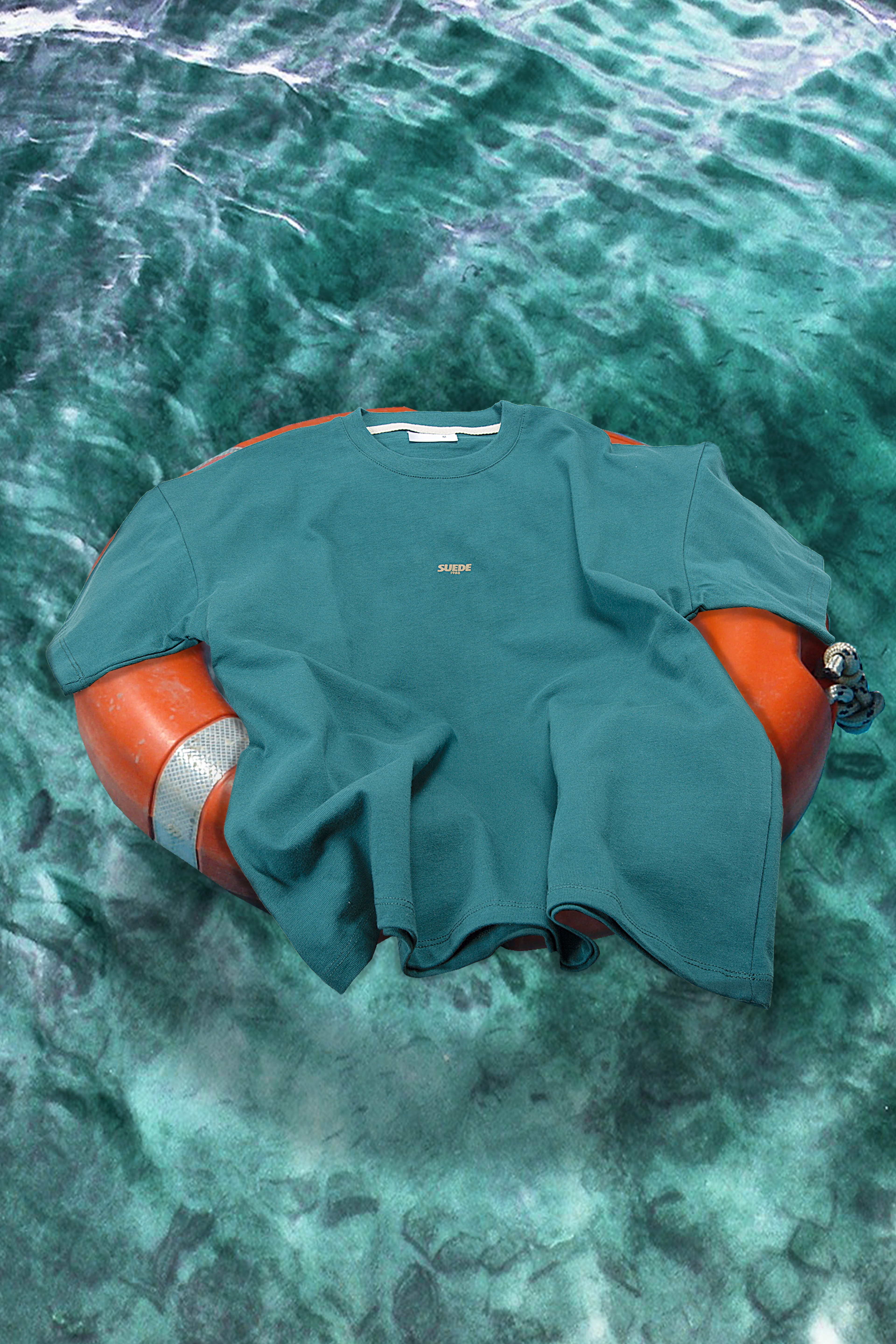 Teal tee on a life ring in Menorca