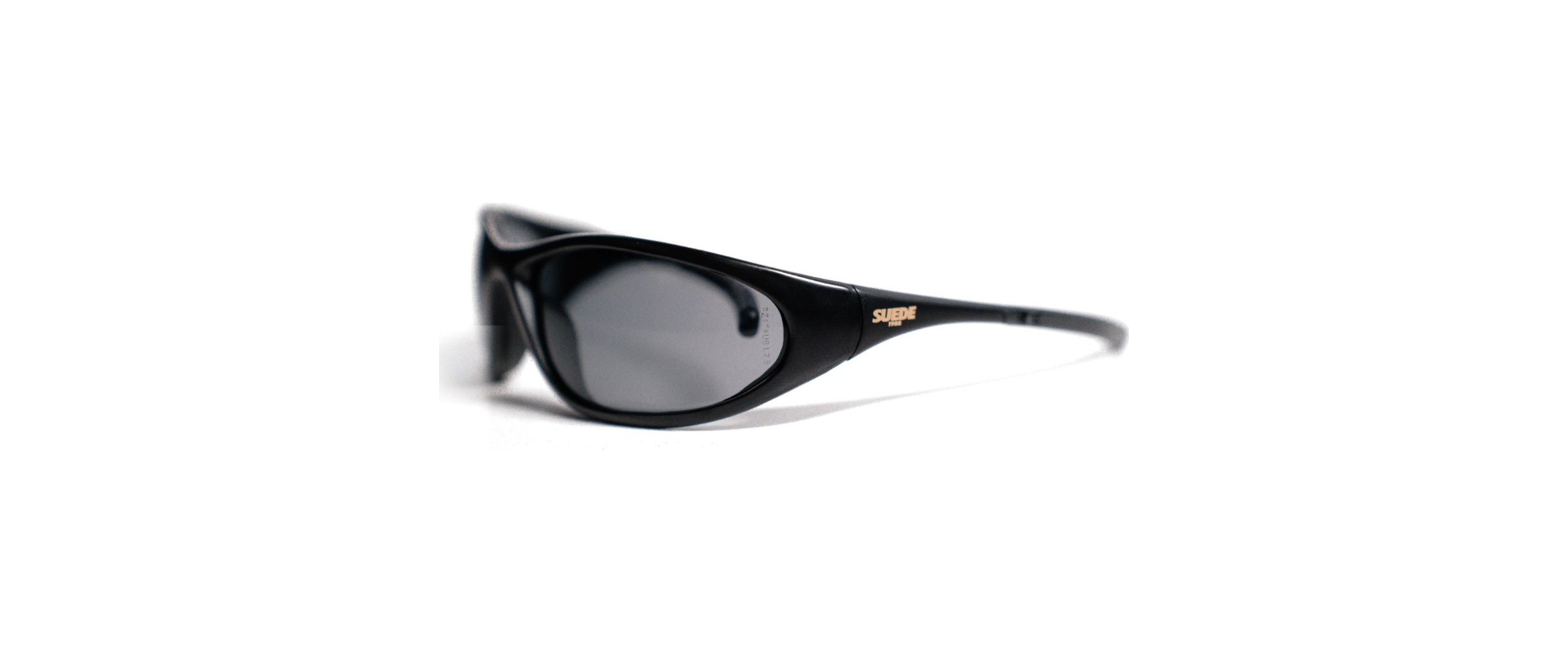 SUEDE1988 wraparound sunglasses, matte black frame with smoke lenses and gold logo on the temple