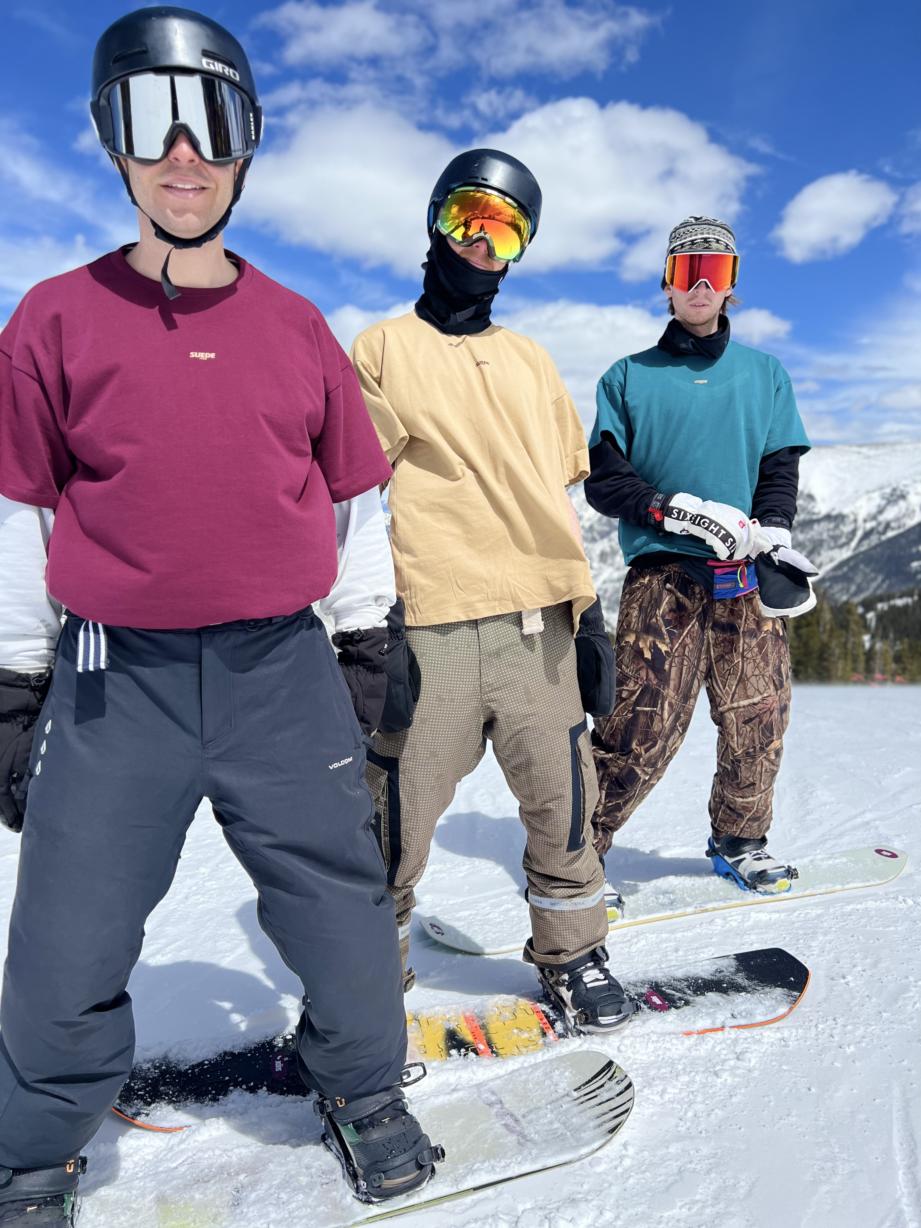 Three riders wearing SUEDE1988 tees on the hill